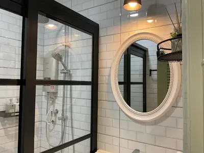 a bathroom with a shower and a mirror at Jessie Home in Bukit Mertajam