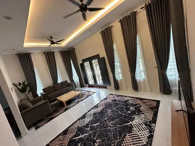a living room with a couch and a ceiling fan at D’Asam Homestay Baling in Baling