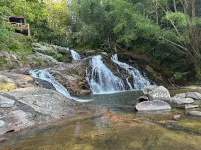 a waterfall in the middle of a river with rocks at D’Asam Homestay Baling in Baling