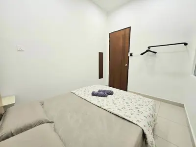 a bedroom with a bed with two towels on it at Air-home No 28 Simpang near Aulong Econsave, 3BR, 7pax, Netflix in Simpang