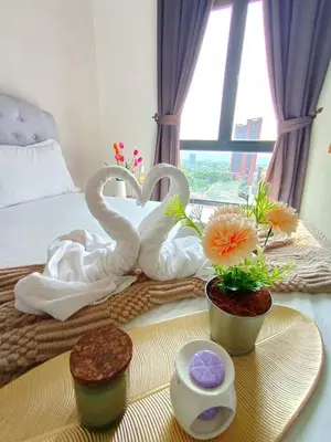 two swansuitsrendered to look like towels on a bed at The Horizon Ipoh Dual L12 by Grab A Stay in Ipoh