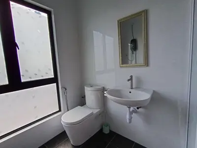 a white bathroom with a toilet and a sink at The Horizon Ipoh Dual L12 by Grab A Stay in Ipoh