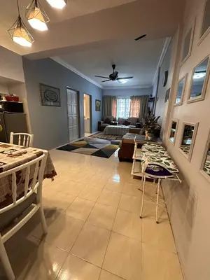 a large living room with a table and a couch at ROYAL LILY TANAH RATA BY JUNIKASTAY in Tanah Rata