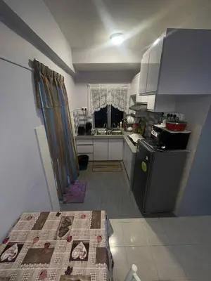 a small kitchen with a sink and a stove at ROYAL LILY TANAH RATA BY JUNIKASTAY in Tanah Rata