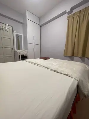 a large white bed in a room with a window at ROYAL LILY TANAH RATA BY JUNIKASTAY in Tanah Rata