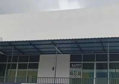 a building with a sign that reads happyiversary usk at Happy homestay in Teluk Intan