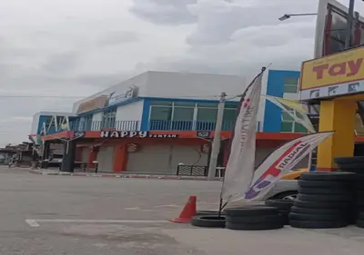 two small sail boats sitting in a parking lot in front of a building at Happy homestay in Teluk Intan