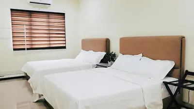 two beds sitting next to each other in a room at Ipoh Urban Retreat 20PAX 5 Room Holiday Villa by City Home Empire in Ipoh