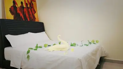 a white bird sitting on a bed with leaves at Ipoh Urban Retreat 20PAX 5 Room Holiday Villa by City Home Empire in Ipoh