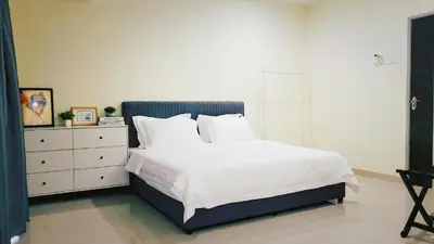 a bedroom with a bed with white sheets and a dresser at Ipoh Urban Retreat 20PAX 5 Room Holiday Villa by City Home Empire in Ipoh