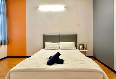 a blue teddy bear laying on a bed at Ipoh IGB Homestay by Comfort Home in Ipoh