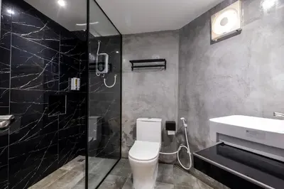 a bathroom with a toilet and a sink and a shower at Boutique Hidden loft in Bukit Mertajam