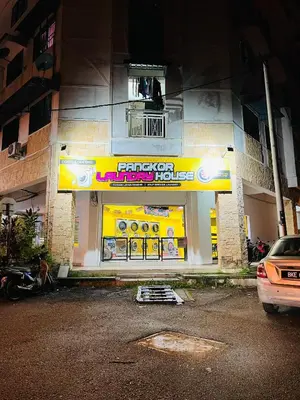 a fast food restaurant with a sign on the side of a building at ShopLot Hostel Pangkor in Pasir Bogak