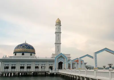 a mosque on the water next to a pier at ShopLot Hostel Pangkor in Pasir Bogak