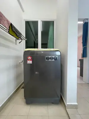 a small refrigerator in a room with a window at Eyu Sweet Home in Sitiawan 10-13 pax free wifi in Sitiawan