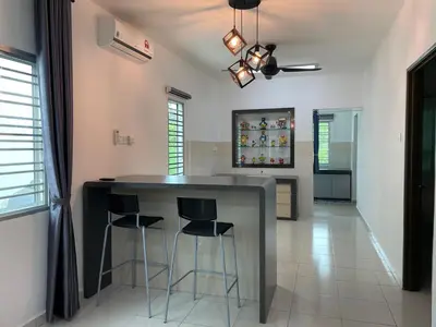 a kitchen with a counter and stools in a room at Eyu Sweet Home in Sitiawan 10-13 pax free wifi in Sitiawan