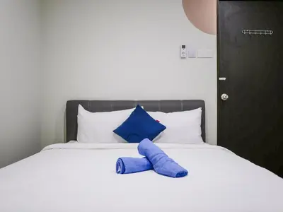 a blue pillow sitting on top of a bed at Cheerful Guesthouse #Adventist#BudgetStay in George Town