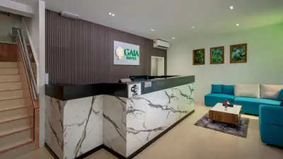 a lobby with a blue couch and a table at GAIA Hotel in Tanjung Bungah
