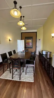 a dining room with a wooden table and chairs at Bukit Ruil Bungalow - Clementine Suite in Tanah Rata