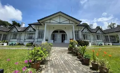 a house with flowers in front of it at Bukit Ruil Bungalow - Clementine Suite in Tanah Rata
