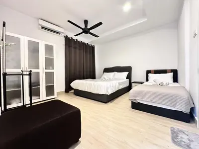 a bedroom with two beds and a ceiling fan at Leisure 1Bedroom Balcony Suites Gurney in George Town