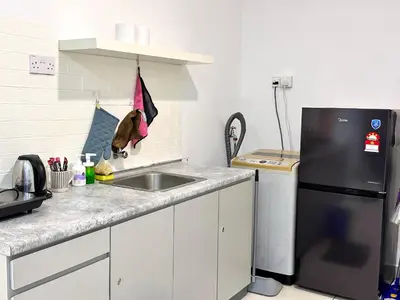 a kitchen with a sink and a refrigerator at Leisure 1Bedroom Balcony Suites Gurney in George Town