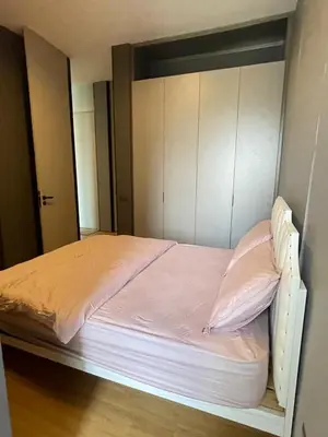 a bedroom with a bed with pink sheets and cabinets at Penang Amazing SeaView Private Lift \u68b9\u57ce\u5bcc\u4eba\u533a\u7edd\u7f8e\u6d77\u666f\u516c\u5bd3\u79c1\u4eba\u7535\u68af in Tanjong Tokong