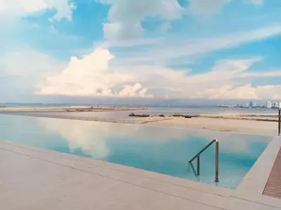 a swimming pool with a view of the beach at Penang Amazing SeaView Private Lift \u68b9\u57ce\u5bcc\u4eba\u533a\u7edd\u7f8e\u6d77\u666f\u516c\u5bd3\u79c1\u4eba\u7535\u68af in Tanjong Tokong