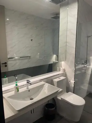a white bathroom with a sink and a toilet at Penang Amazing SeaView Private Lift \u68b9\u57ce\u5bcc\u4eba\u533a\u7edd\u7f8e\u6d77\u666f\u516c\u5bd3\u79c1\u4eba\u7535\u68af in Tanjong Tokong