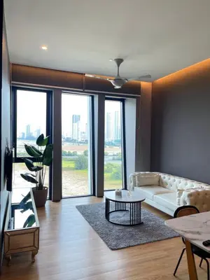 a living room with a white couch and a table at Penang Amazing SeaView Private Lift \u68b9\u57ce\u5bcc\u4eba\u533a\u7edd\u7f8e\u6d77\u666f\u516c\u5bd3\u79c1\u4eba\u7535\u68af in Tanjong Tokong