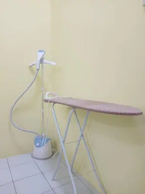 a table with a hose on top of it at KhaAfi Homestay Seri Iskandar in Kampung Bota Kiri