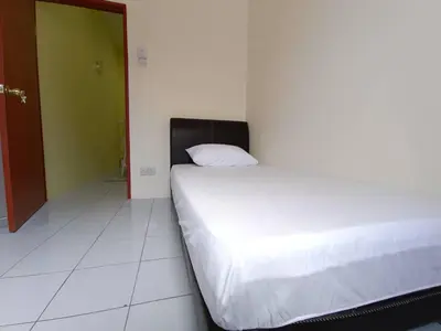 a bed in a room with a white floor at KhaAfi Homestay Seri Iskandar in Kampung Bota Kiri