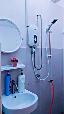 a bathroom with a shower with a sink and a mirror at COZY, FAMILYSTAY, BAYAN LEPAS, only 4pax, 1car parking in Bayan Lepas