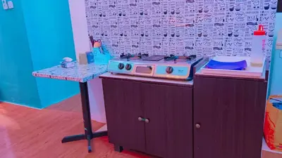 a toy kitchen with a stove and a table at COZY, FAMILYSTAY, BAYAN LEPAS, only 4pax, 1car parking in Bayan Lepas