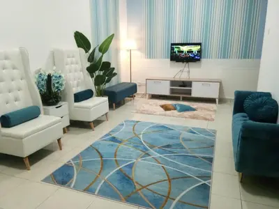 a living room with two chairs and a tv at Imans Homestay Lumut in Seri Manjung