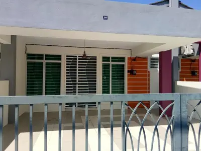 a front porch of a house with green shutters at Imans Homestay Lumut in Seri Manjung