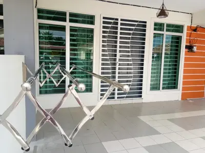 a metal fence in front of a house at Imans Homestay Lumut in Seri Manjung