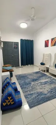 a living room with a couch and a rug at Imans Homestay Lumut in Seri Manjung