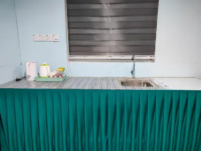a kitchen with a green counter and a sink at Homestay Teratak D`kemangi with Private Pool in Baling