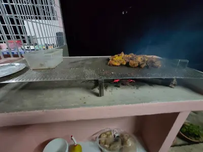 a grill with food on top of a table at Homestay Teratak D`kemangi with Private Pool in Baling
