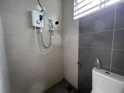 a bathroom with a shower and a toilet in it at Ipoh Family Cozy Homestay 4R4B 12-13pax SY23 in Ipoh