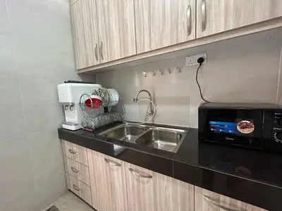 a kitchen with a sink and a microwave at Ipoh Family Cozy Homestay 4R4B 12-13pax SY23 in Ipoh