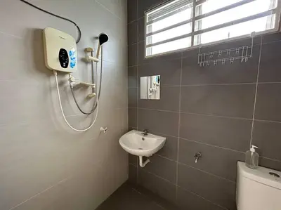 a bathroom with a shower and a sink and a toilet at Ipoh Family Cozy Homestay 4R4B 12-13pax SY23 in Ipoh
