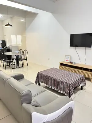 a living room with a couch and a table at Cameron Double Story @ Golden Hill in Brinchang