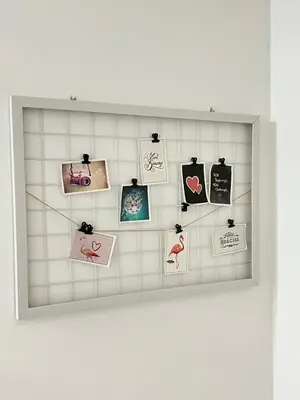 a framed picture of photos on a tiled wall at Cameron Double Story @ Golden Hill in Brinchang