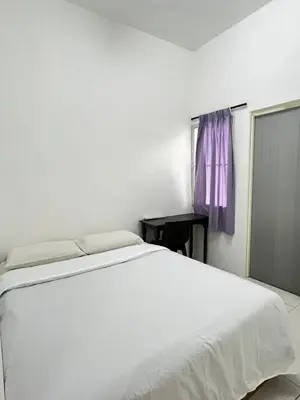 a bedroom with a white bed and a window at Cameron Double Story @ Golden Hill in Brinchang