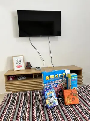 a room with a table with books and a tv at Cameron Double Story @ Golden Hill in Brinchang