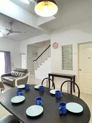 a living room with a table and a couch at Cameron Double Story @ Golden Hill in Brinchang