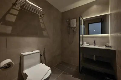 a bathroom with a toilet and a sink and a mirror at Macalister 288 in George Town