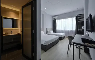 a hotel room with two beds and a desk at Macalister 288 in George Town